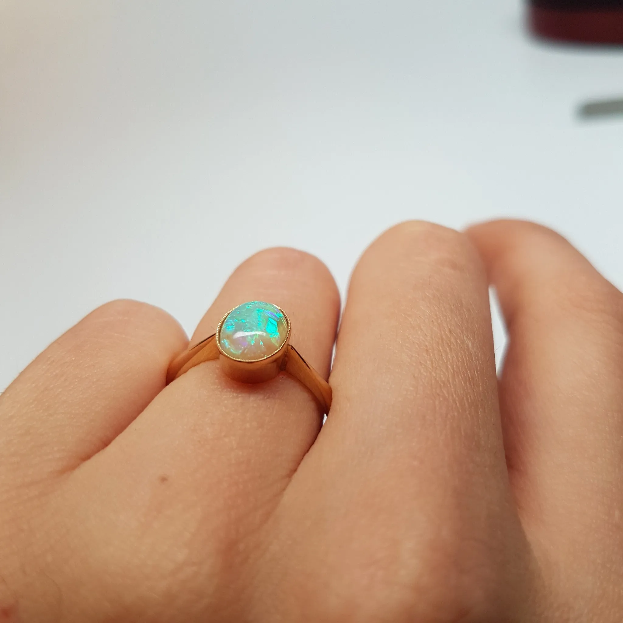 18K YELLOW GOLD AND BEZEL SET OPAL SOLITAIRE RING