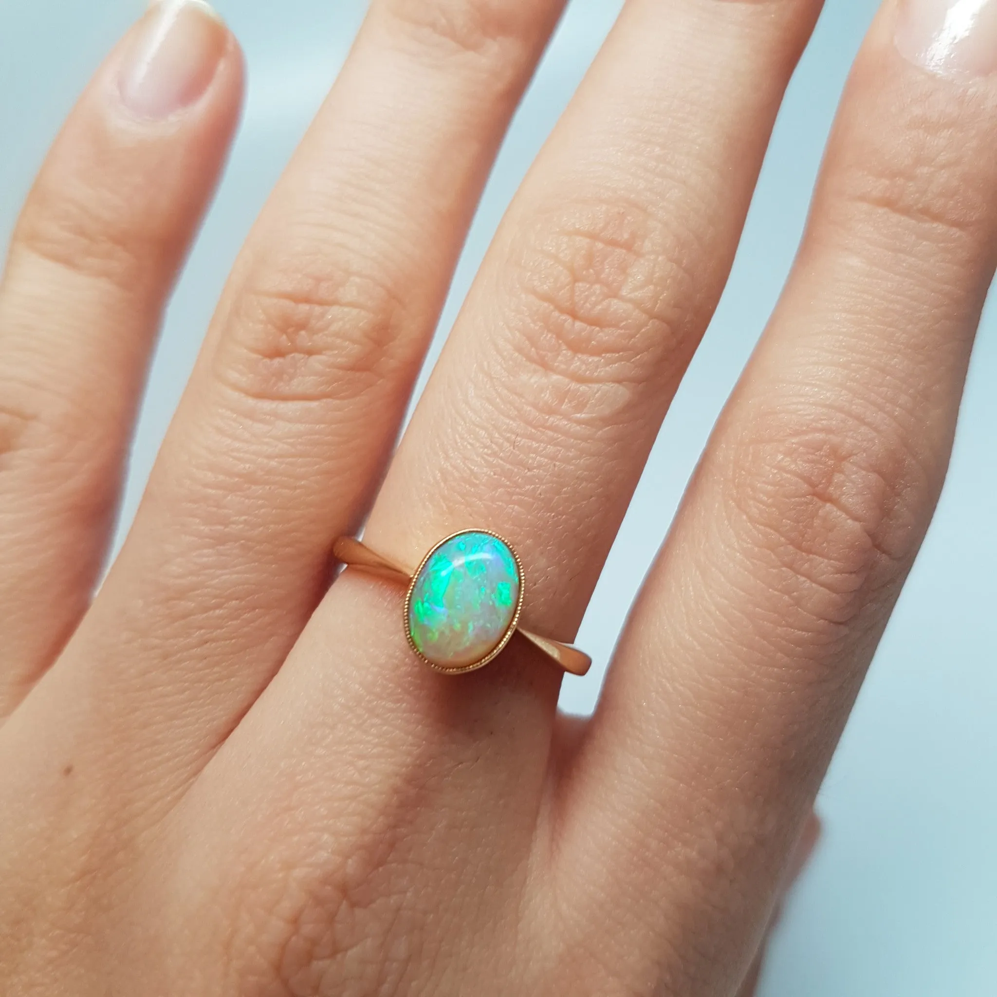 18K YELLOW GOLD AND BEZEL SET OPAL SOLITAIRE RING