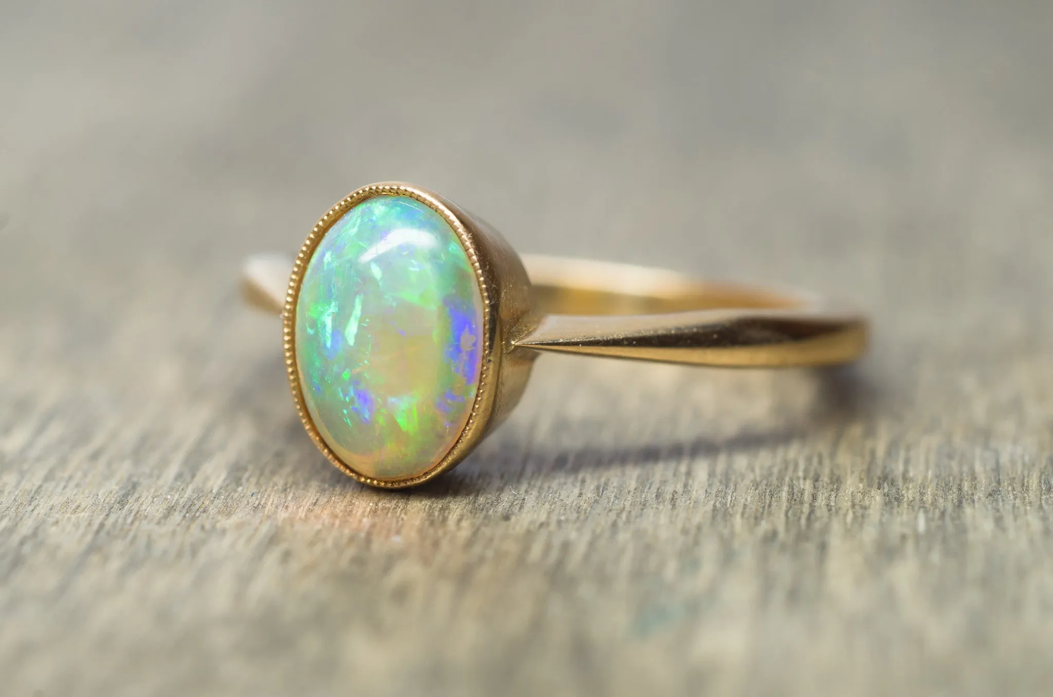 18K YELLOW GOLD AND BEZEL SET OPAL SOLITAIRE RING