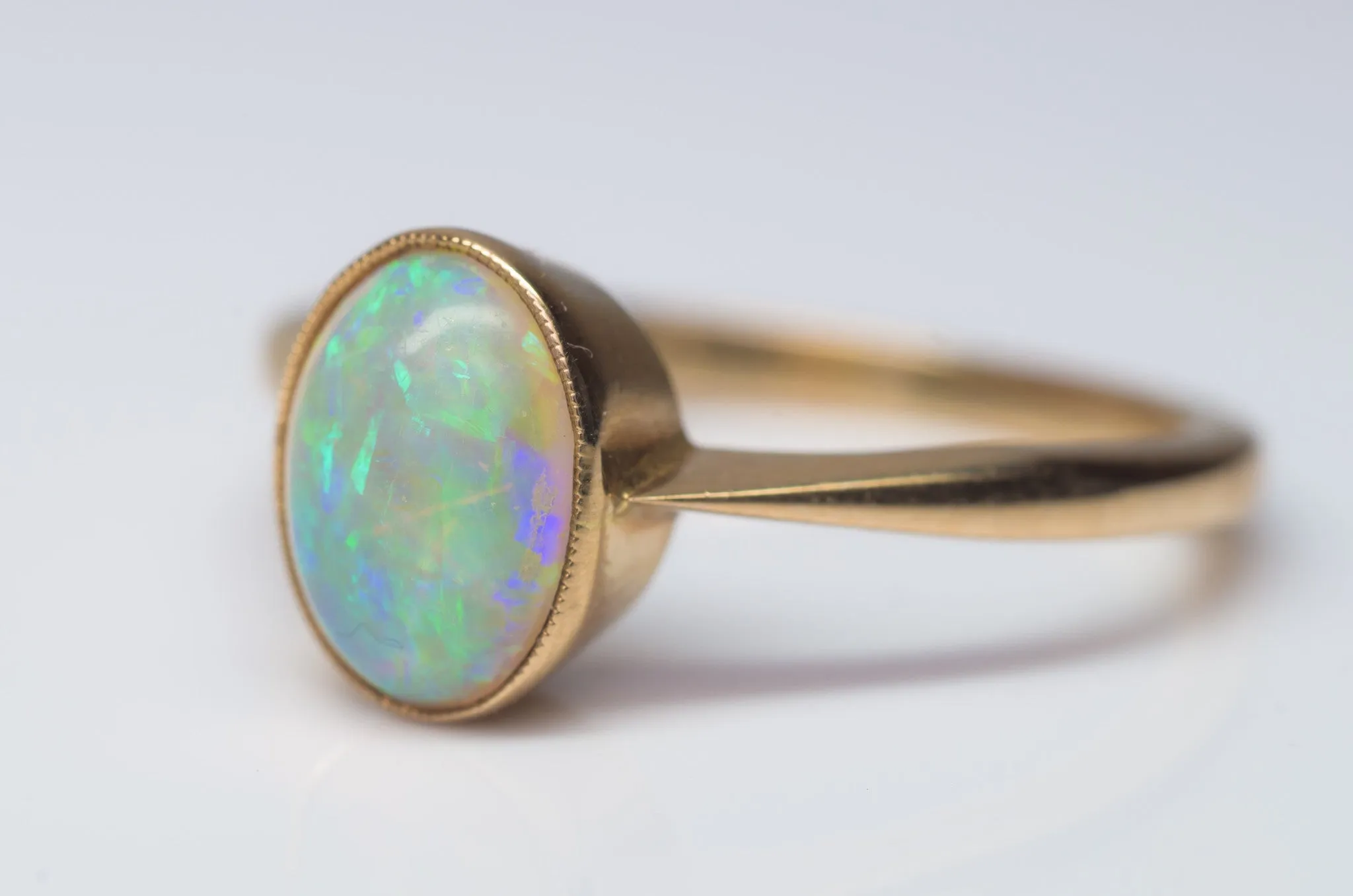 18K YELLOW GOLD AND BEZEL SET OPAL SOLITAIRE RING