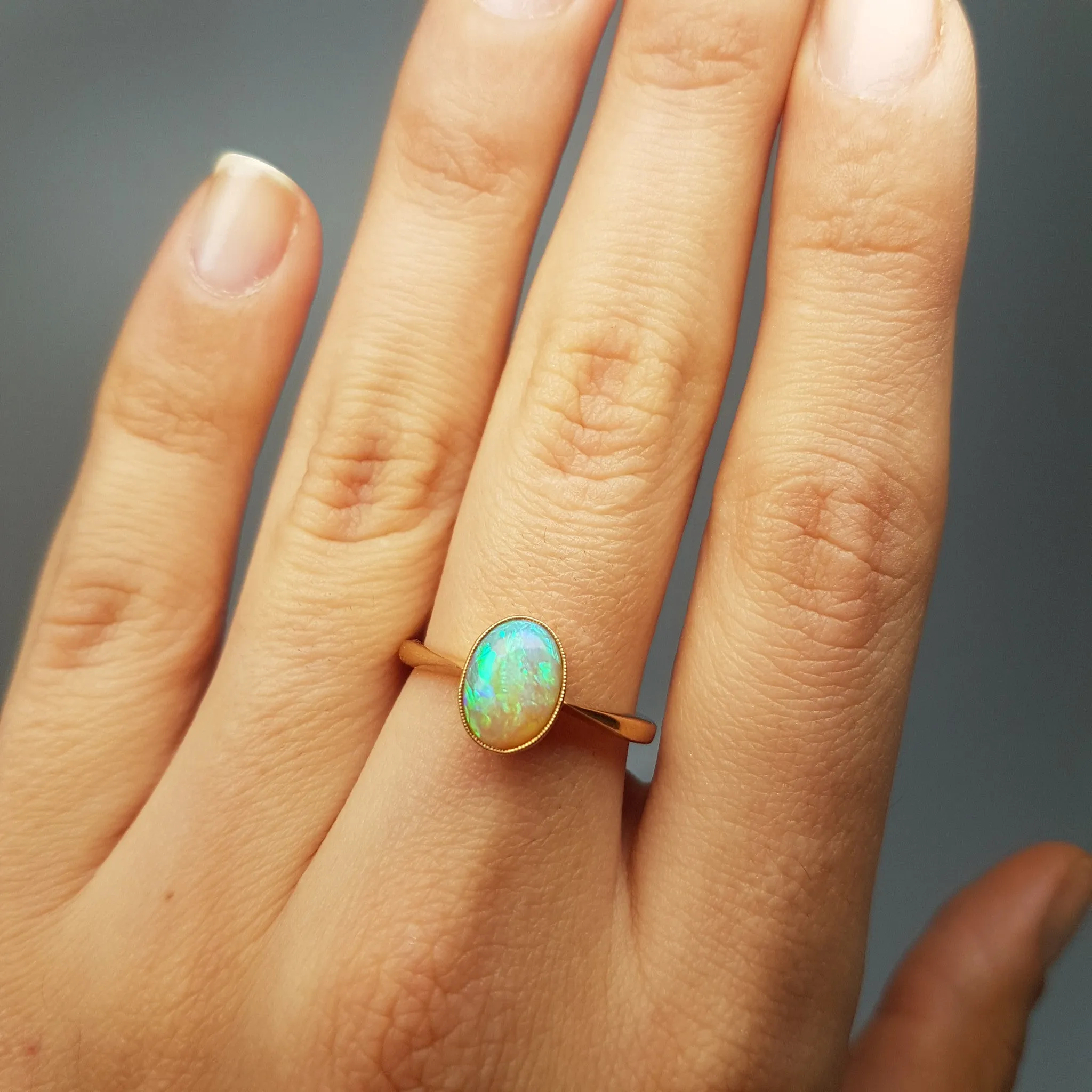 18K YELLOW GOLD AND BEZEL SET OPAL SOLITAIRE RING