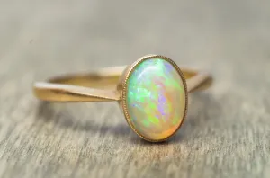 18K YELLOW GOLD AND BEZEL SET OPAL SOLITAIRE RING