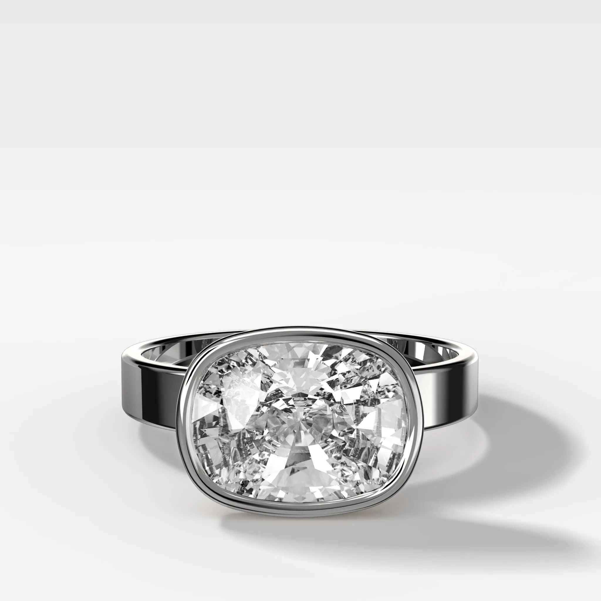 Finest Bezel Set Engagement Ring With East West Elongated Cushion Cut Diamond