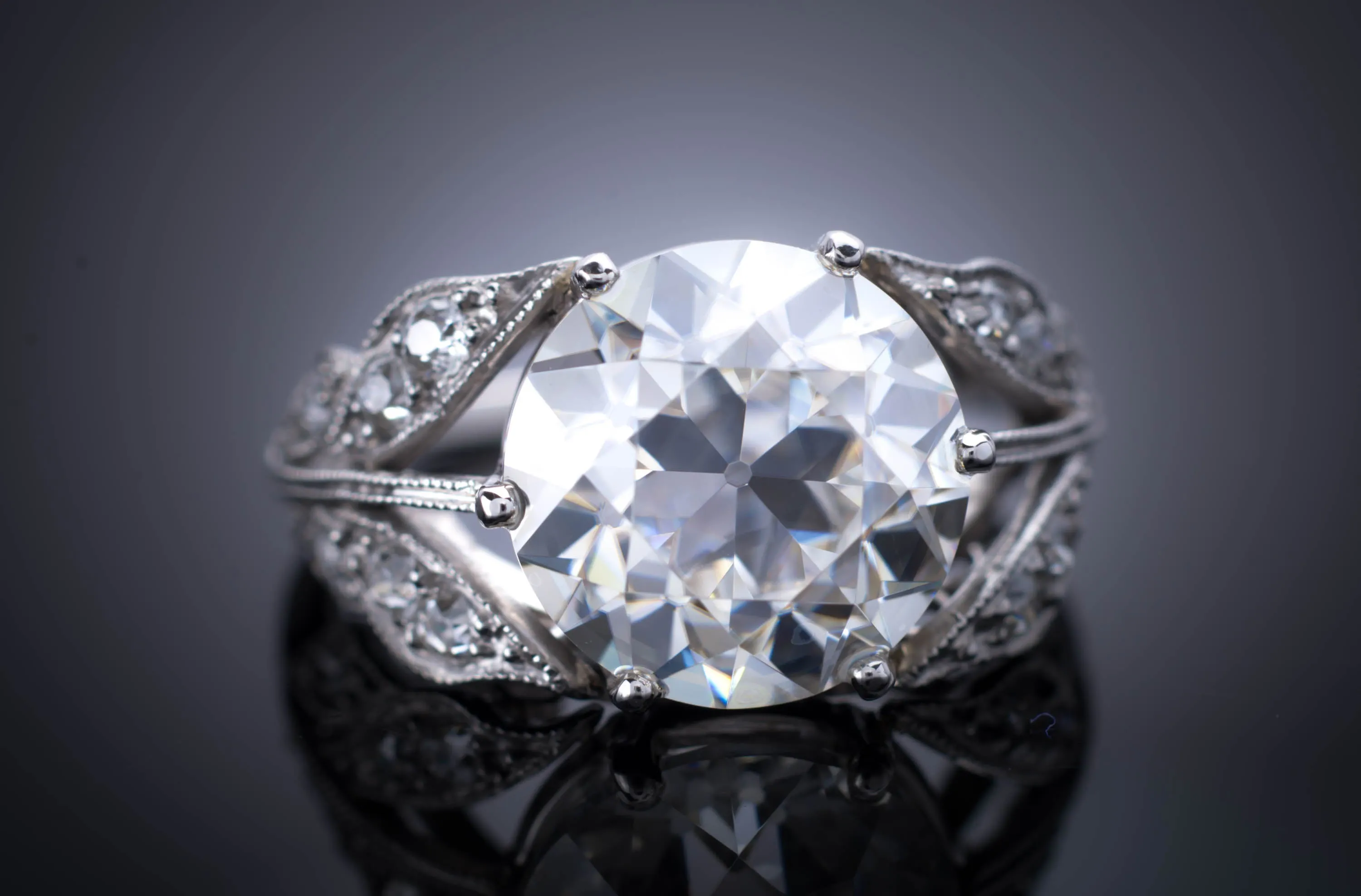 SOLITAIRE IN PLATINUM WITH DIAMOND ACCENTS