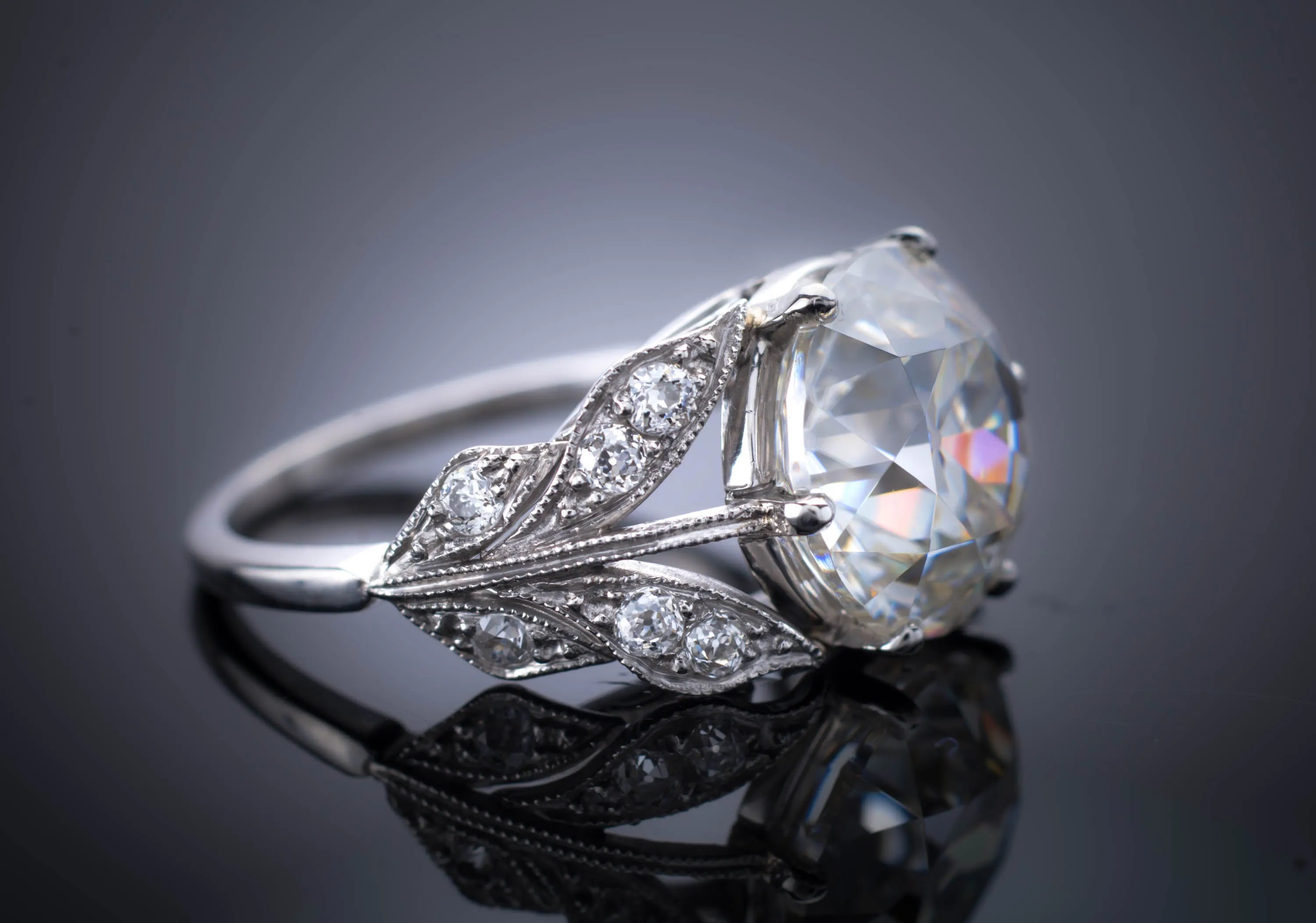 SOLITAIRE IN PLATINUM WITH DIAMOND ACCENTS