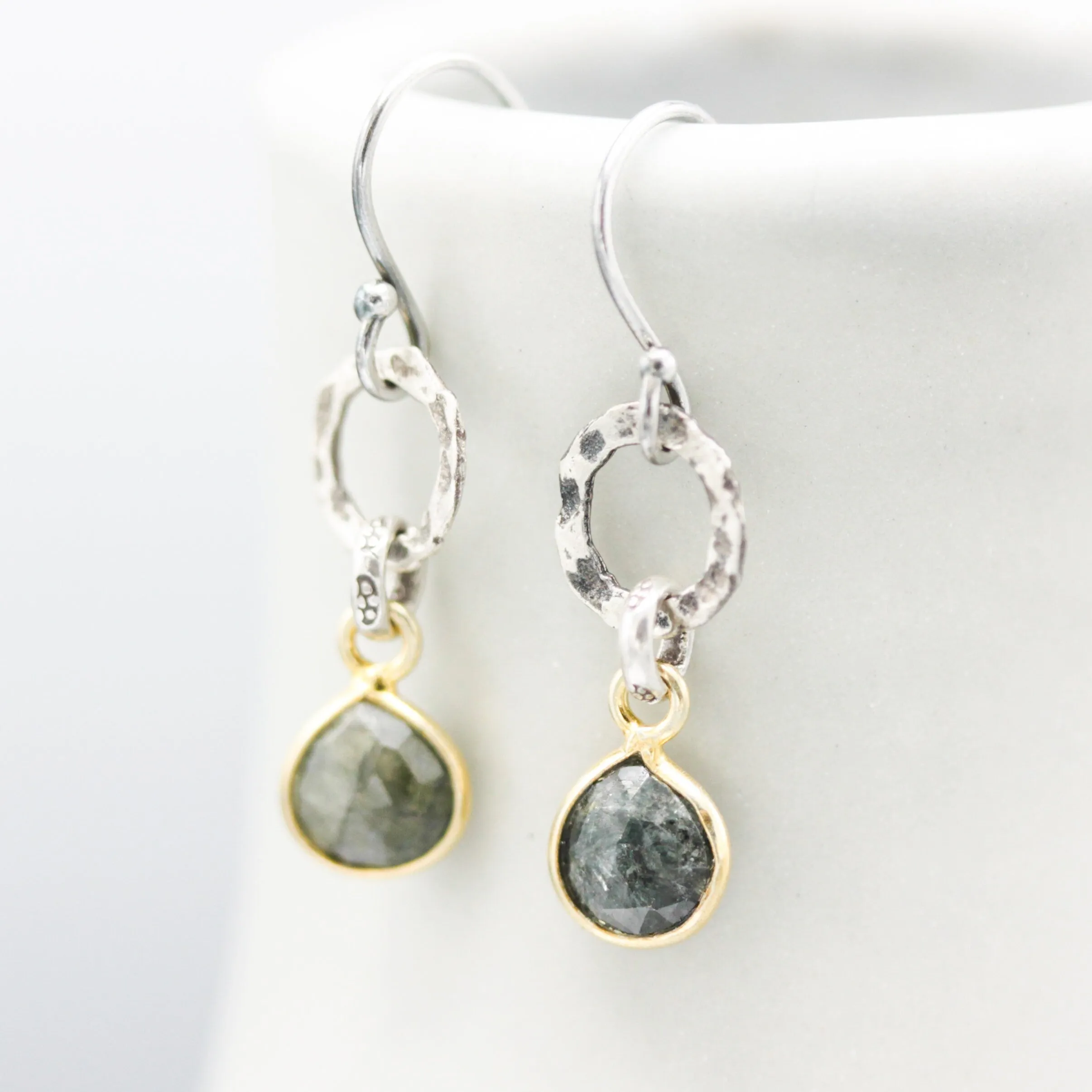 Teardrop faceted Emerald earrings in silver bezel setting with silver circle shape and hooks style on the top