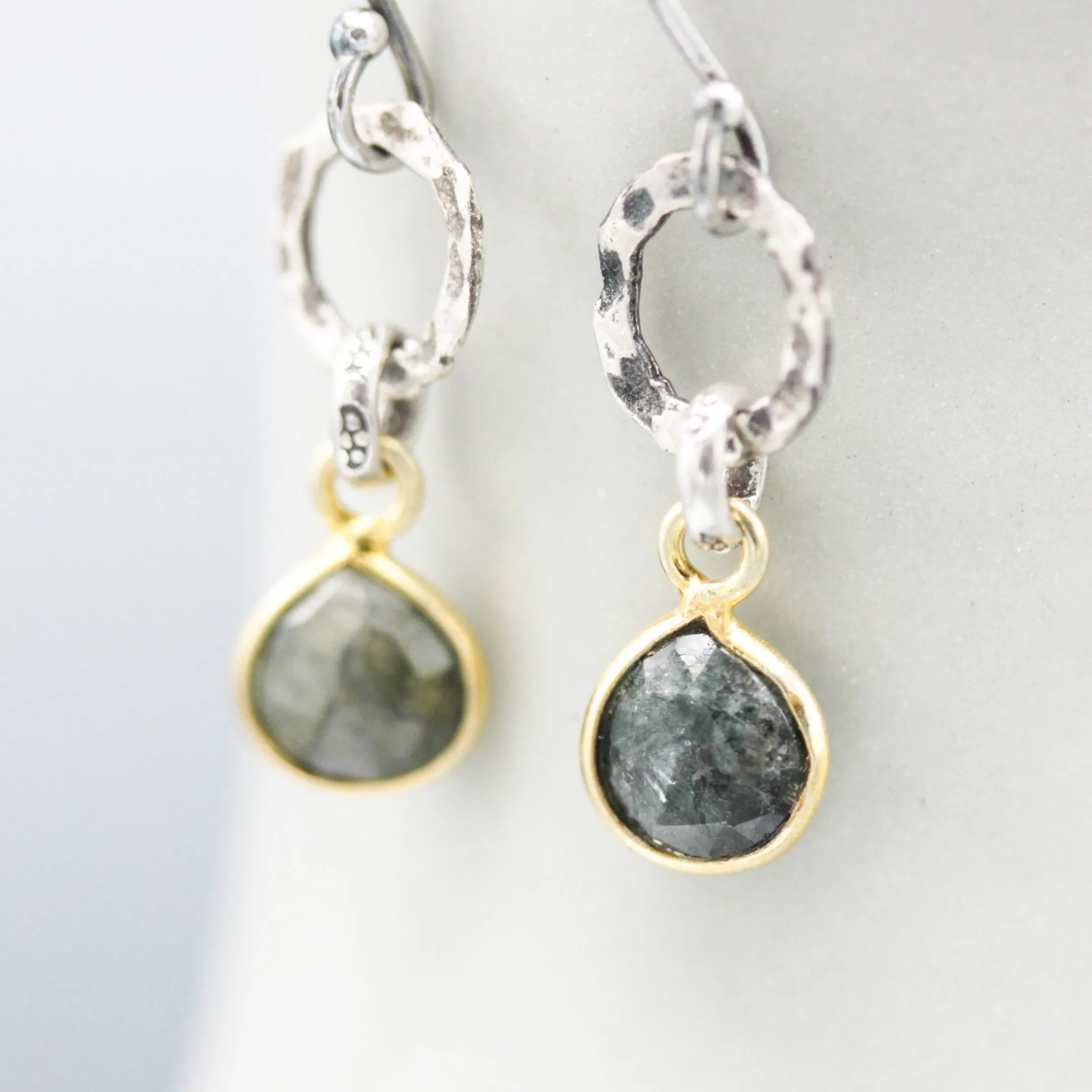 Teardrop faceted Emerald earrings in silver bezel setting with silver circle shape and hooks style on the top