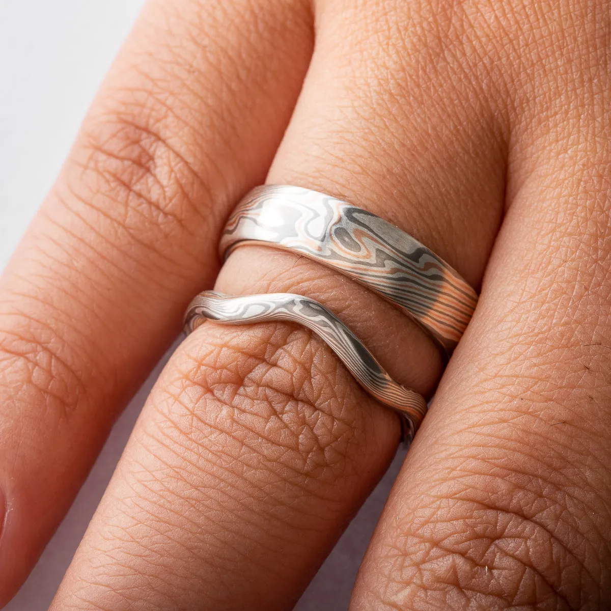 Unique Mokume Gane Rings or Wedding Band Set with Contoured Band in Twist Pattern in Ash & Embers Palette with Red Gold Stratum