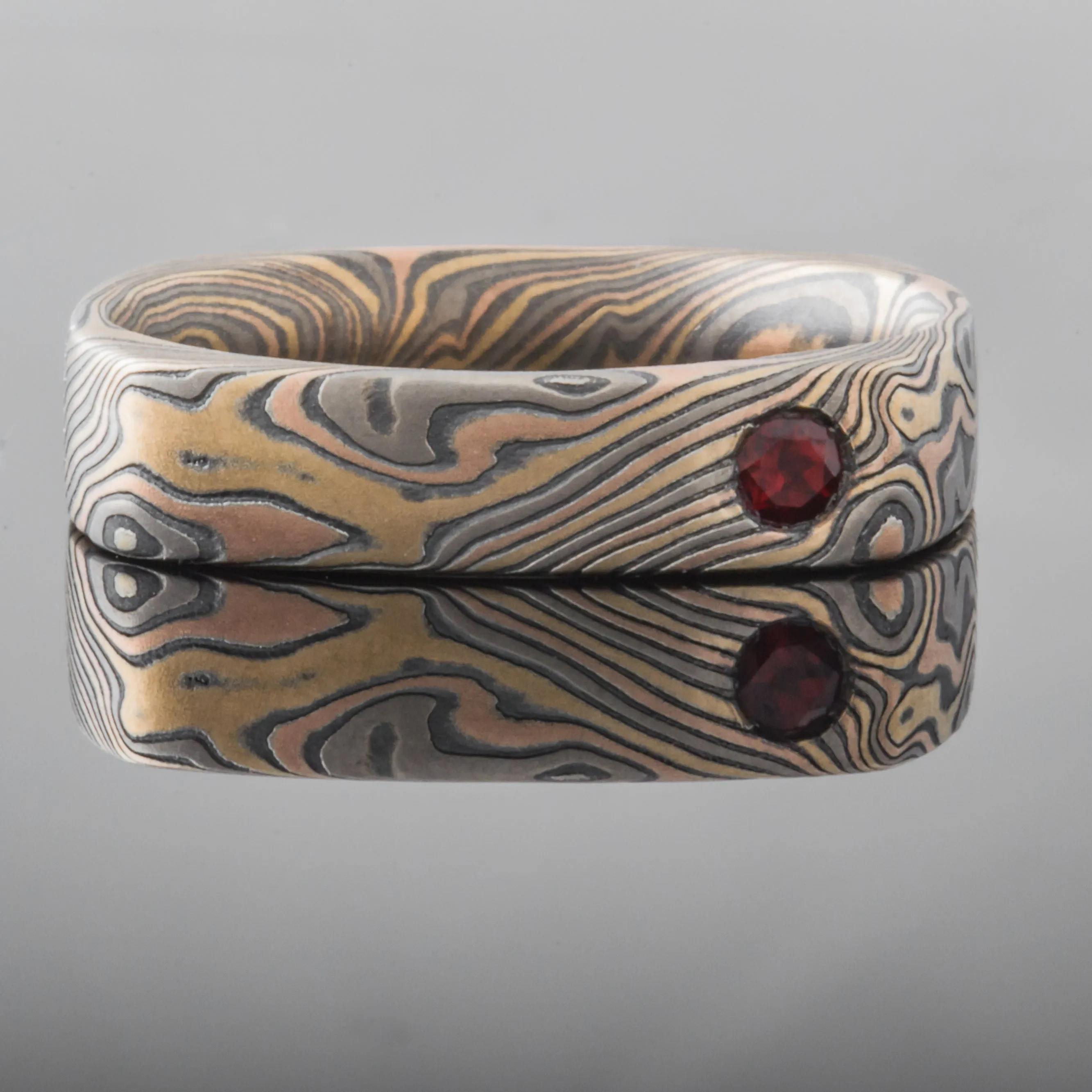Unique Mokume Gane Square Wedding Band or Ring in Twist Pattern and Firestorm Palette with added Garnet